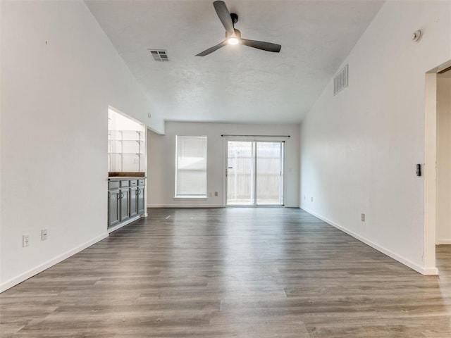 704 NW 137th St, Edmond, OK 73013 - unfurnished living room with ceiling fan and wood finished floors