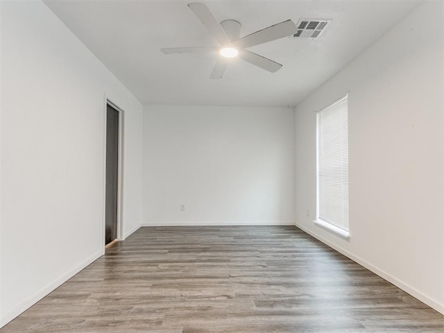 704 NW 137th St, Edmond, OK 73013 - empty room with ceiling fan, wood finished floors, and plenty of natural light