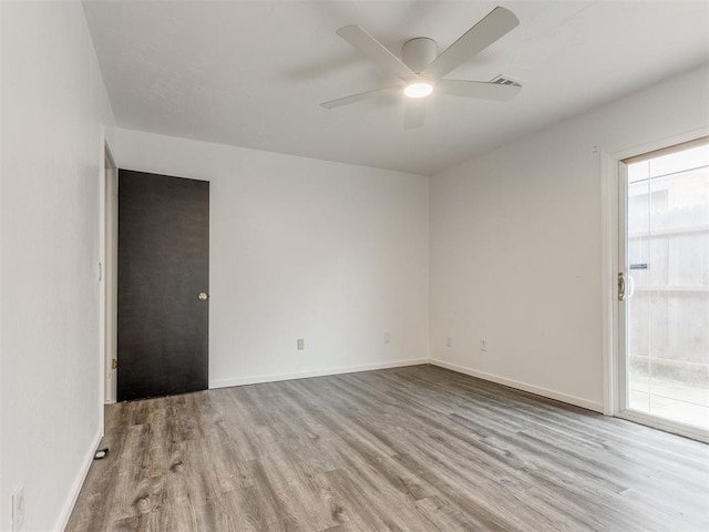 704 NW 137th St, Edmond, OK 73013 - unfurnished room featuring wood finished floors and a ceiling fan
