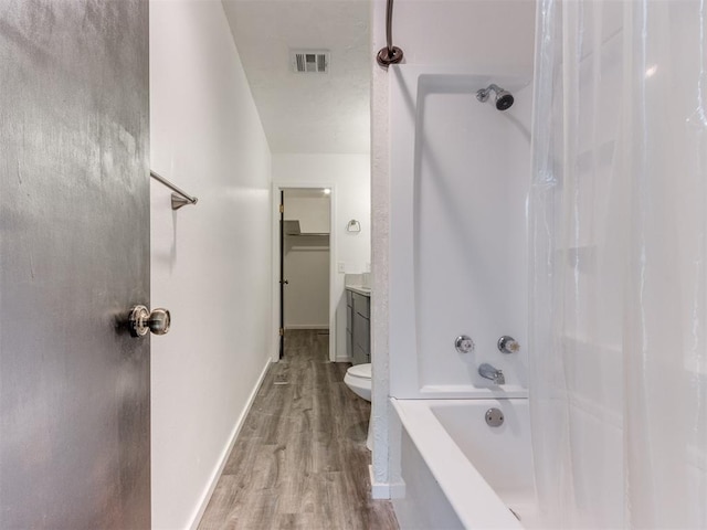 704 NW 137th St, Edmond, OK 73013 - full bathroom featuring wood finished floors, vanity, and shower / bathtub combination with curtain
