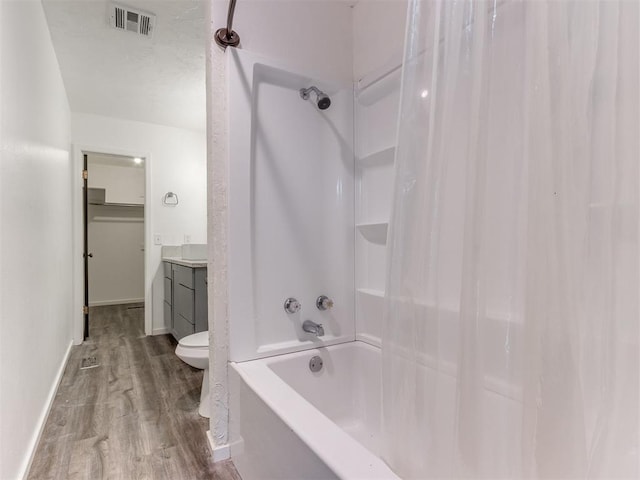 704 NW 137th St, Edmond, OK 73013 - full bathroom featuring wood finished floors, shower / tub combo, and vanity