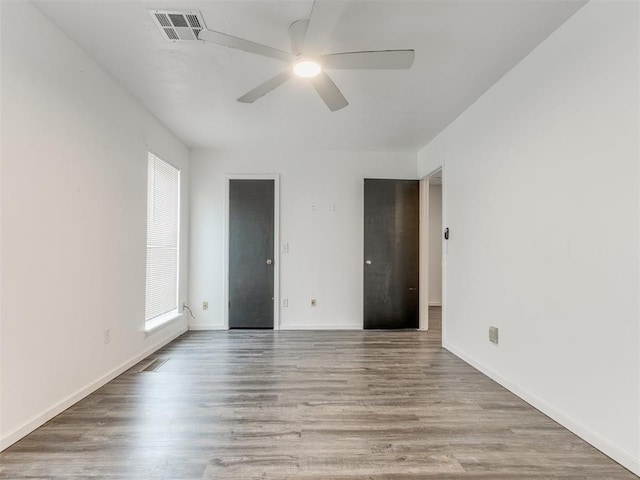 704 NW 137th St, Edmond, OK 73013 - unfurnished bedroom featuring wood finished floors and a ceiling fan