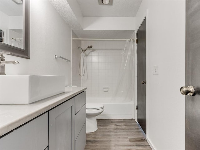 704 NW 137th St, Edmond, OK 73013 - full bathroom featuring vanity, bathtub / shower combination, wood finished floors, and a textured ceiling