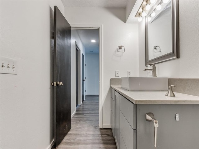 704 NW 137th St, Edmond, OK 73013 - bathroom featuring vanity and wood finished floors