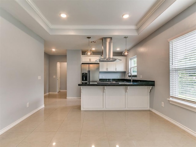 2248 NW 22nd St, Oklahoma City, OK 73107 - kitchen with stainless steel fridge with ice dispenser, island range hood, a peninsula, a raised ceiling, and crown molding