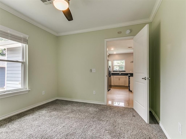 2248 NW 22nd St, Oklahoma City, OK 73107 - empty room with light carpet, ceiling fan, ornamental molding, and a smoke detector