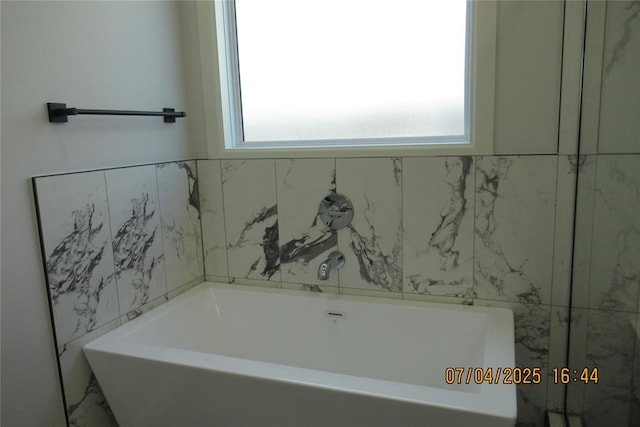 15901 Sarno Ln, Edmond, OK 73013 - bathroom featuring plenty of natural light and a bathtub