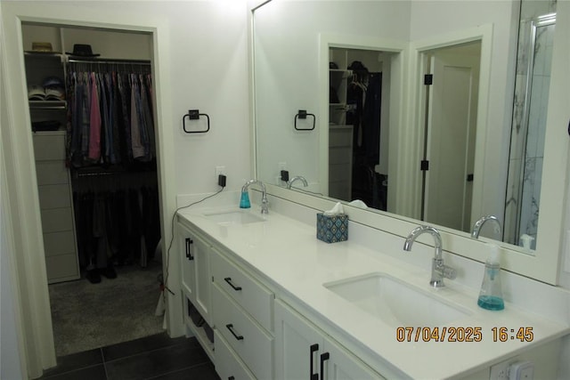 15901 Sarno Ln, Edmond, OK 73013 - full bath with double vanity, tile patterned flooring, a walk in closet, and a stall shower