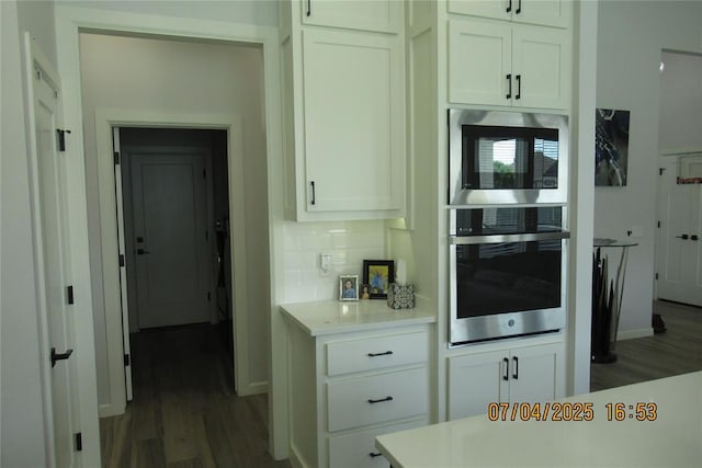 15901 Sarno Ln, Edmond, OK 73013 - kitchen with stainless steel appliances, wood finished floors, white cabinetry, and light countertops