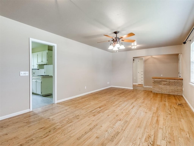 119 Thompson Dr, Moore, OK 73160 - empty room with a ceiling fan and wood finished floors