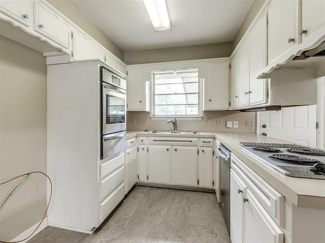 119 Thompson Dr, Moore, OK 73160 - kitchen featuring appliances with stainless steel finishes, a warming drawer, light countertops, and white cabinets