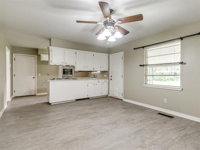 119 Thompson Dr, Moore, OK 73160 - kitchen featuring a ceiling fan, white cabinets, light countertops, and oven