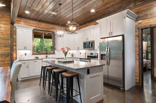 2105 Pine Hills Rd, Broken Bow, OK 74728 - kitchen with stainless steel appliances, concrete flooring, wooden ceiling, decorative backsplash, and white cabinetry