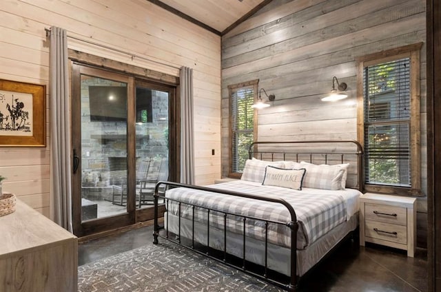 2105 Pine Hills Rd, Broken Bow, OK 74728 - bedroom featuring finished concrete floors, wood walls, vaulted ceiling, access to exterior, and multiple windows