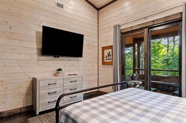 2105 Pine Hills Rd, Broken Bow, OK 74728 - bedroom with wood walls, access to exterior, and vaulted ceiling