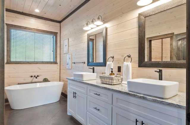 2105 Pine Hills Rd, Broken Bow, OK 74728 - bathroom with wooden walls, double vanity, finished concrete floors, a freestanding tub, and wood ceiling