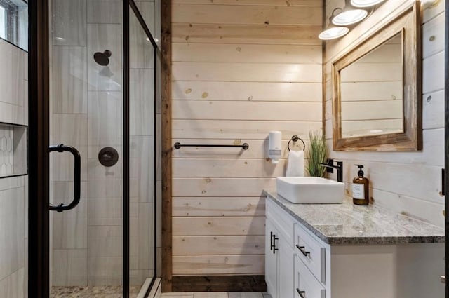 2105 Pine Hills Rd, Broken Bow, OK 74728 - bathroom with vanity, a shower stall, and wood walls