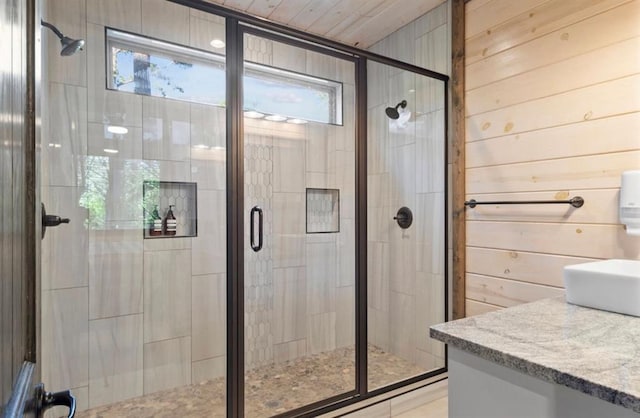 2105 Pine Hills Rd, Broken Bow, OK 74728 - bathroom with a shower stall, vanity, and wood walls