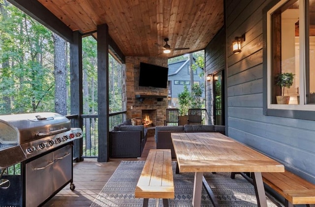 2105 Pine Hills Rd, Broken Bow, OK 74728 - wooden deck with a ceiling fan, area for grilling, and an outdoor living space with a fireplace