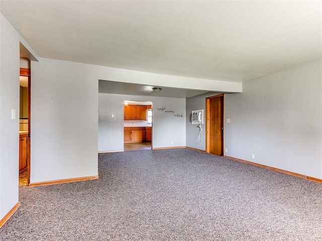 3240 SW 119th St, Oklahoma City, OK 73170 - unfurnished living room featuring a wall mounted air conditioner and carpet flooring