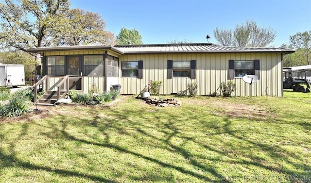20536 S 417th W Ave, Bristow, OK 74010 - rear view of property with a yard, a metal roof, and a sunroom