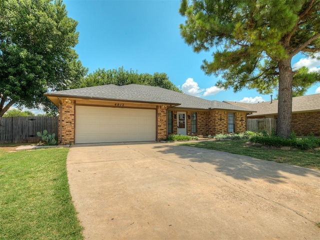 4812 Hunton Ter, Yukon, OK 73099 - ranch-style home with brick siding, a garage, and concrete driveway