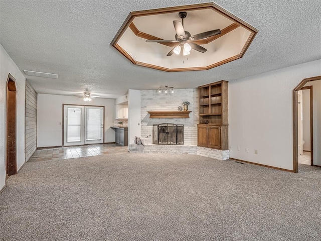 4812 Hunton Ter, Yukon, OK 73099 - unfurnished living room with a ceiling fan, carpet flooring, a textured ceiling, and a fireplace