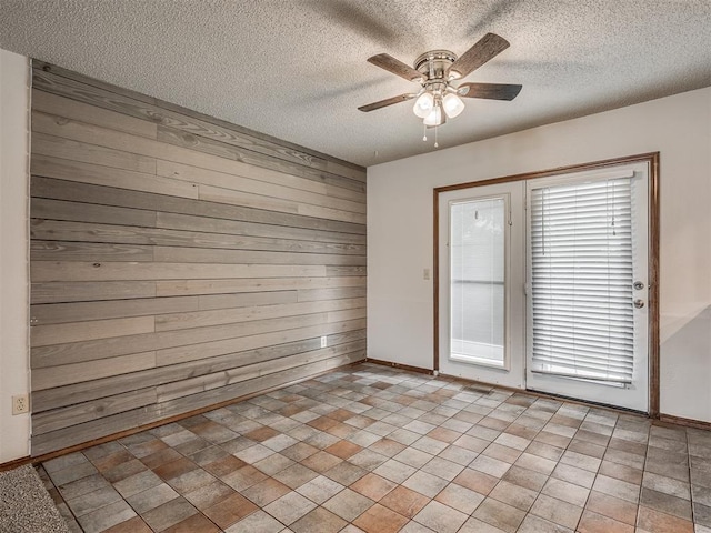 4812 Hunton Ter, Yukon, OK 73099 - unfurnished room featuring wood walls, a ceiling fan, and a textured ceiling