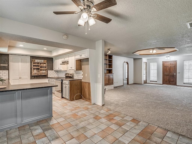 4812 Hunton Ter, Yukon, OK 73099 - kitchen with stainless steel electric range oven, dark countertops, ceiling fan, a textured ceiling, and ventilation hood