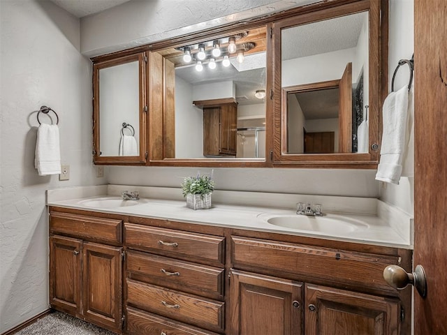 4812 Hunton Ter, Yukon, OK 73099 - bathroom with double vanity, a textured wall, and a shower with shower door