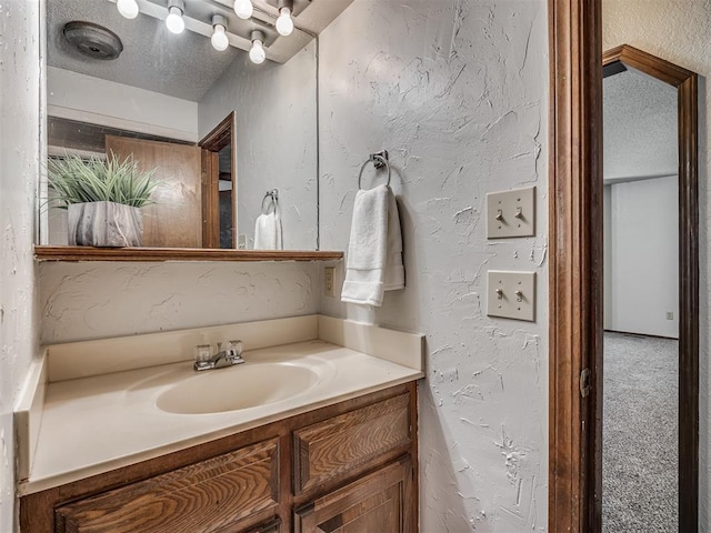 4812 Hunton Ter, Yukon, OK 73099 - bathroom with vanity, a textured wall, and a textured ceiling