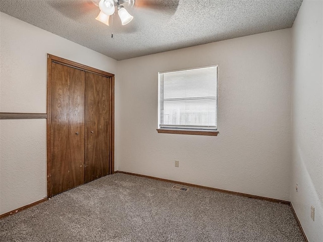 4812 Hunton Ter, Yukon, OK 73099 - unfurnished bedroom with carpet floors, a closet, a textured ceiling, and ceiling fan