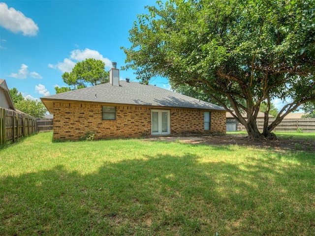 4812 Hunton Ter, Yukon, OK 73099 - rear view of property with a chimney, a fenced backyard, french doors, and brick siding