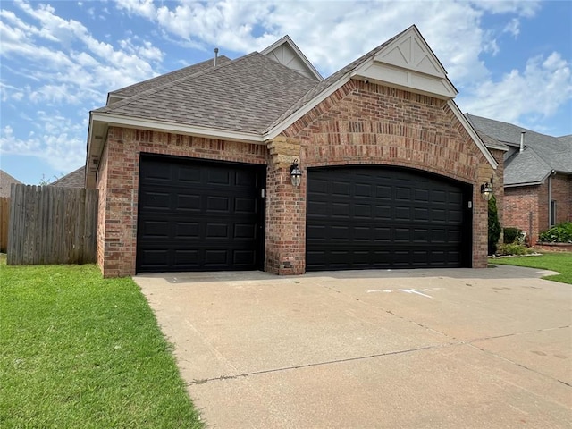 1016 Erinova Dr, Yukon, OK 73099 - view of front of home featuring brick siding, concrete driveway, a shingled roof, and an attached garage