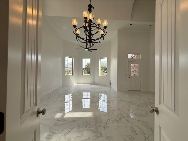 1016 Erinova Dr, Yukon, OK 73099 - empty room featuring crown molding, a chandelier, and light marble finish floors