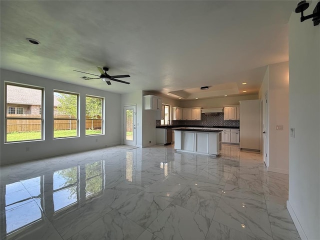 1016 Erinova Dr, Yukon, OK 73099 - unfurnished living room with light marble finish floors, a ceiling fan, and recessed lighting