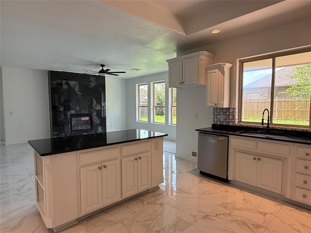 1016 Erinova Dr, Yukon, OK 73099 - kitchen with dishwasher, light marble finish flooring, backsplash, dark countertops, and recessed lighting