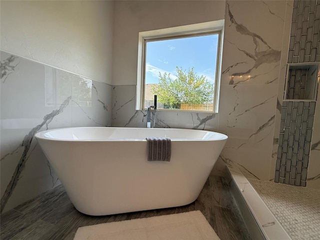 1016 Erinova Dr, Yukon, OK 73099 - bathroom featuring tile walls, a freestanding bath, and marble finish flooring