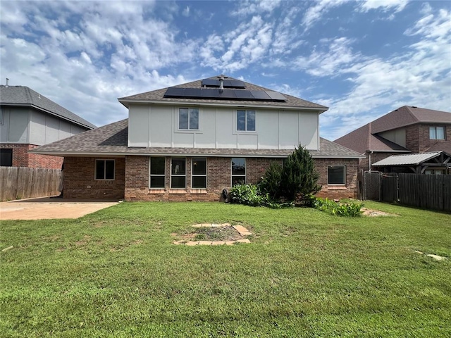 1016 Erinova Dr, Yukon, OK 73099 - rear view of property featuring a patio, solar panels, a fenced backyard, and roof with shingles