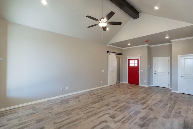 1624 NE 32nd St, Moore, OK 73160 - empty room with a barn door, beam ceiling, ceiling fan, light wood-type flooring, and high vaulted ceiling