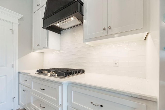 1624 NE 32nd St, Moore, OK 73160 - kitchen featuring premium range hood, stainless steel gas cooktop, and white cabinetry