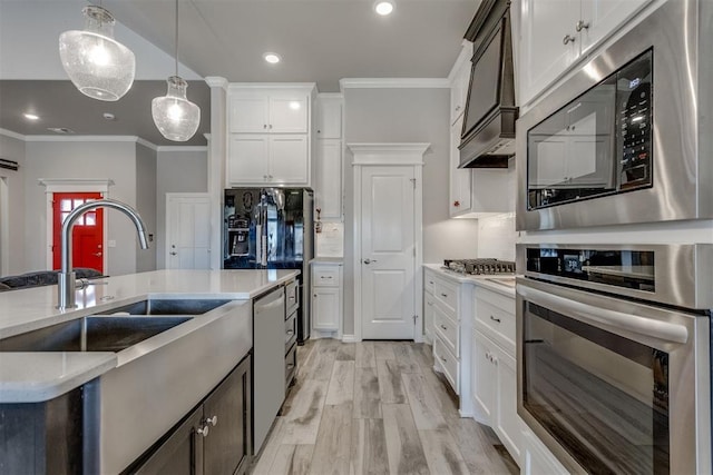 1624 NE 32nd St, Moore, OK 73160 - kitchen featuring appliances with stainless steel finishes, ornamental molding, pendant lighting, white cabinetry, and light wood-type flooring