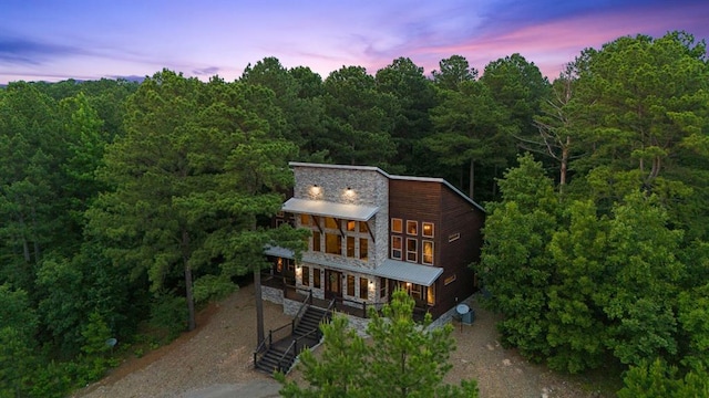 229 Sweet Gum Trl, Broken Bow, OK 74728 - view of front of house featuring driveway, covered porch, stairs, a wooded view, and a metal roof