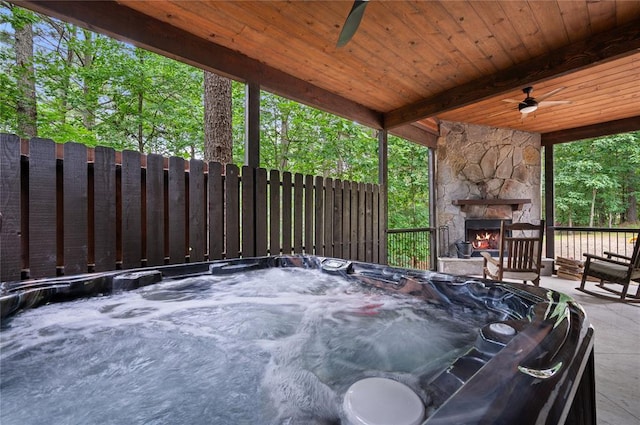 229 Sweet Gum Trl, Broken Bow, OK 74728 - view of patio with an outdoor stone fireplace, a ceiling fan, and a hot tub