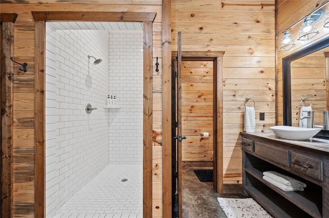 229 Sweet Gum Trl, Broken Bow, OK 74728 - bathroom featuring vanity, a tile shower, and wood walls