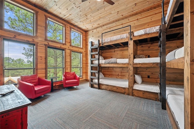 229 Sweet Gum Trl, Broken Bow, OK 74728 - bedroom with wooden ceiling, multiple windows, wood walls, and carpet