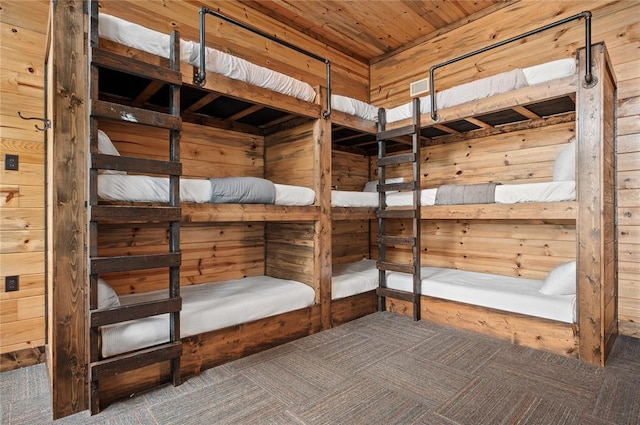 229 Sweet Gum Trl, Broken Bow, OK 74728 - unfurnished bedroom with wood walls, carpet, and wooden ceiling