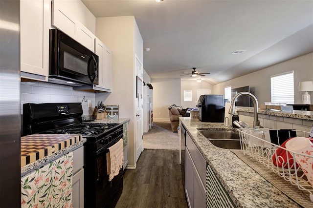 11725 Casey Dr, Yukon, OK 73099 - kitchen with black appliances, open floor plan, dark wood-style floors, backsplash, and ceiling fan
