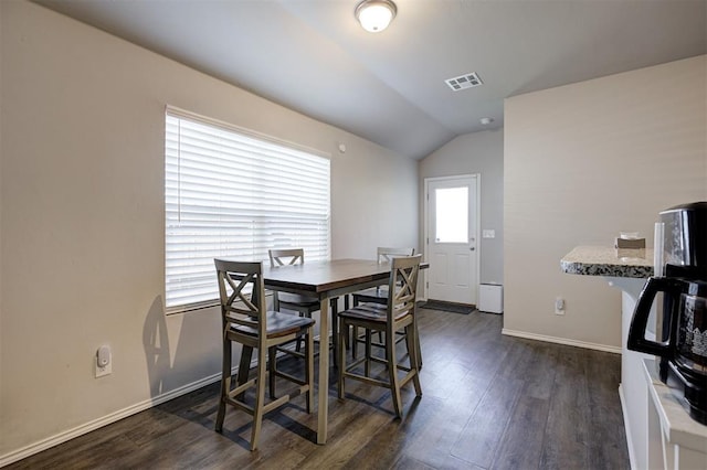 11725 Casey Dr, Yukon, OK 73099 - dining space featuring vaulted ceiling and dark wood-type flooring