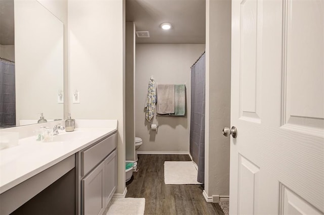 11725 Casey Dr, Yukon, OK 73099 - bathroom with wood finished floors, vanity, and curtained shower